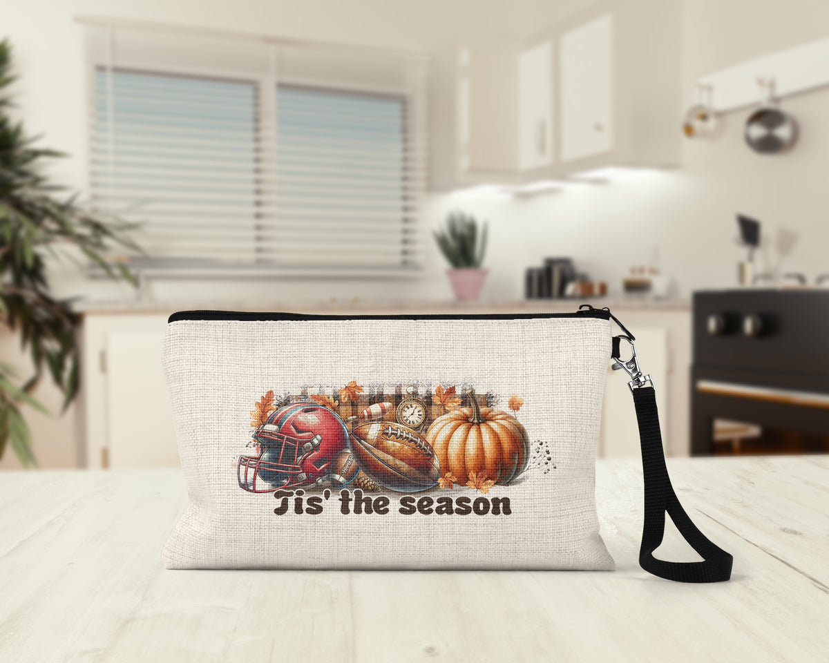 Tis the Season Football Makeup Bag on a kitchen counter