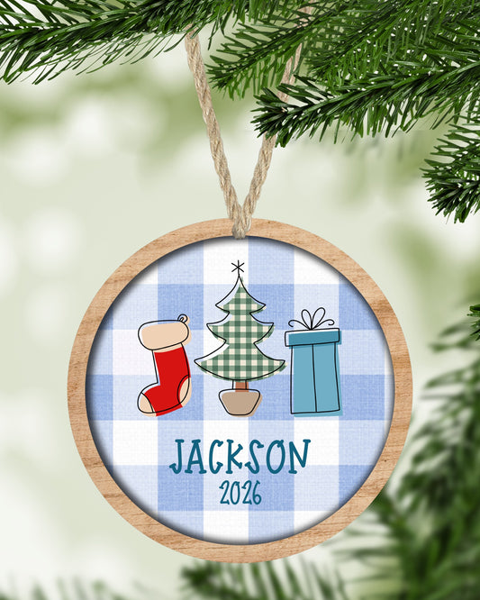Blue Plaid Round Name Christmas ornament hanging on a Christmas tree - The Painted Pug