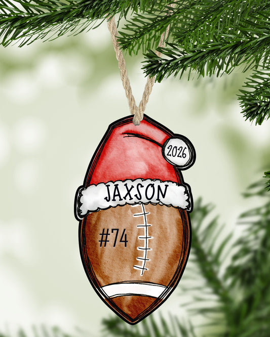 Football Christmas ornament hanging on a Christmas tree - The Painted Pug