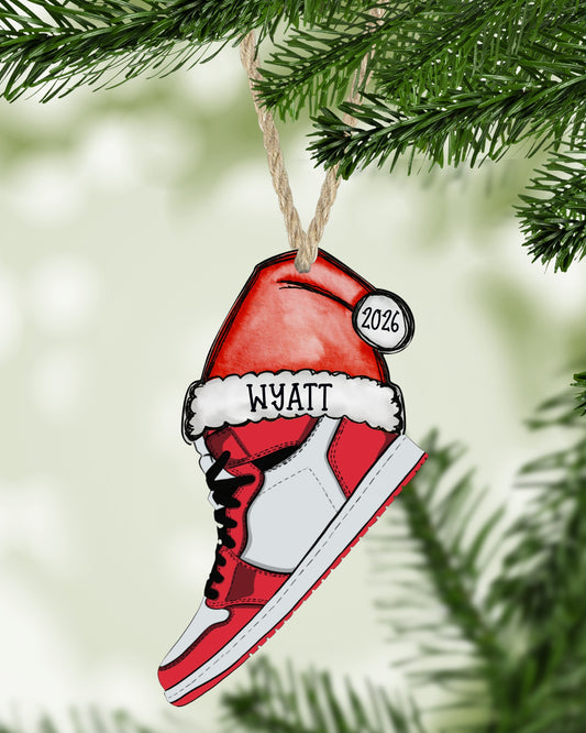 Red, white and black sneaker Christmas ornament hanging on a Christmas tree - The Painted Pug