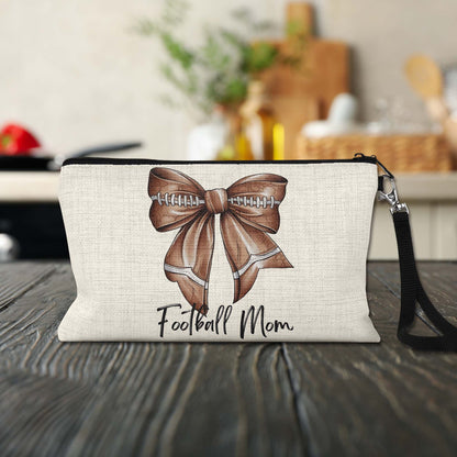 Football Mom Bow Makeup Bag on a kitchen counter