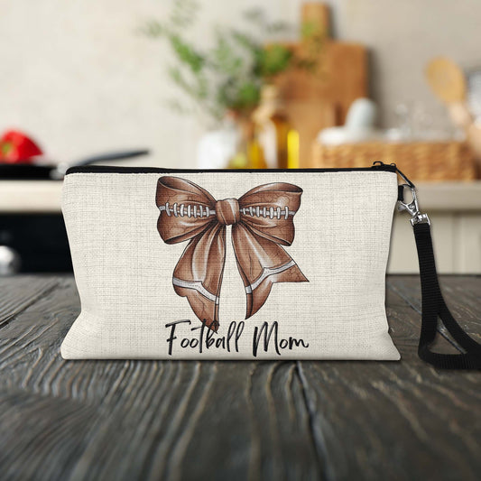 Football Mom Bow Makeup Bag on a kitchen counter