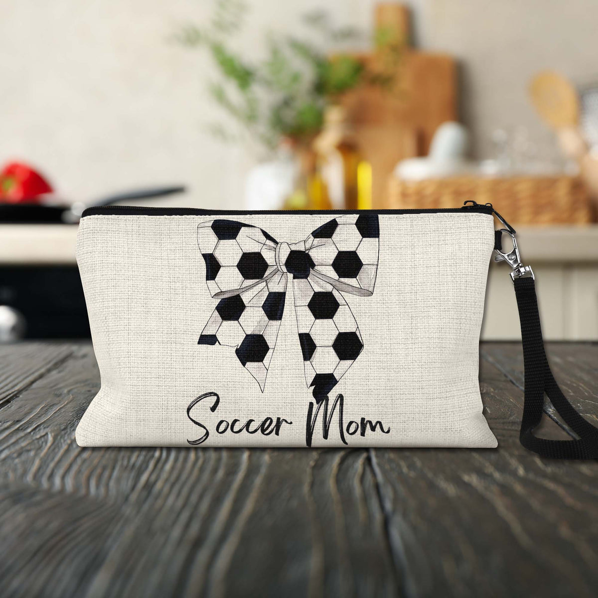 Soccer Mom Bow Makeup Bag on a kitchen counter