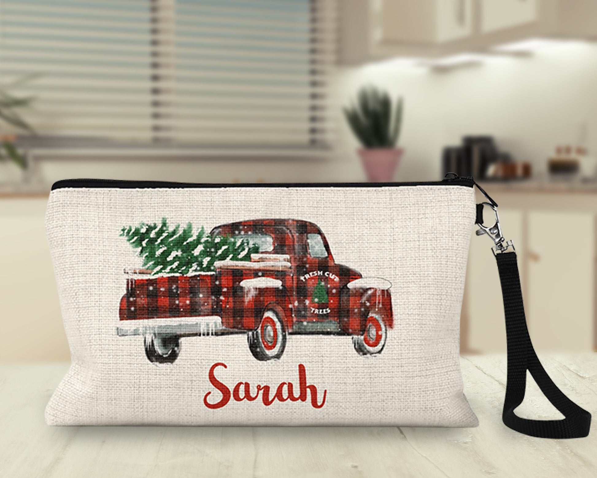 Personalized red truck Christmas Makeup Bag on a kitchen counter