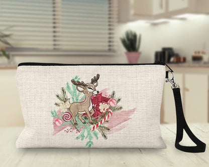Pink watercolor reindeer Makeup Bag on a kitchen counter