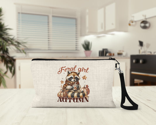 Feral Girl Autumn Raccoon Makeup Bag on a kitchen counter